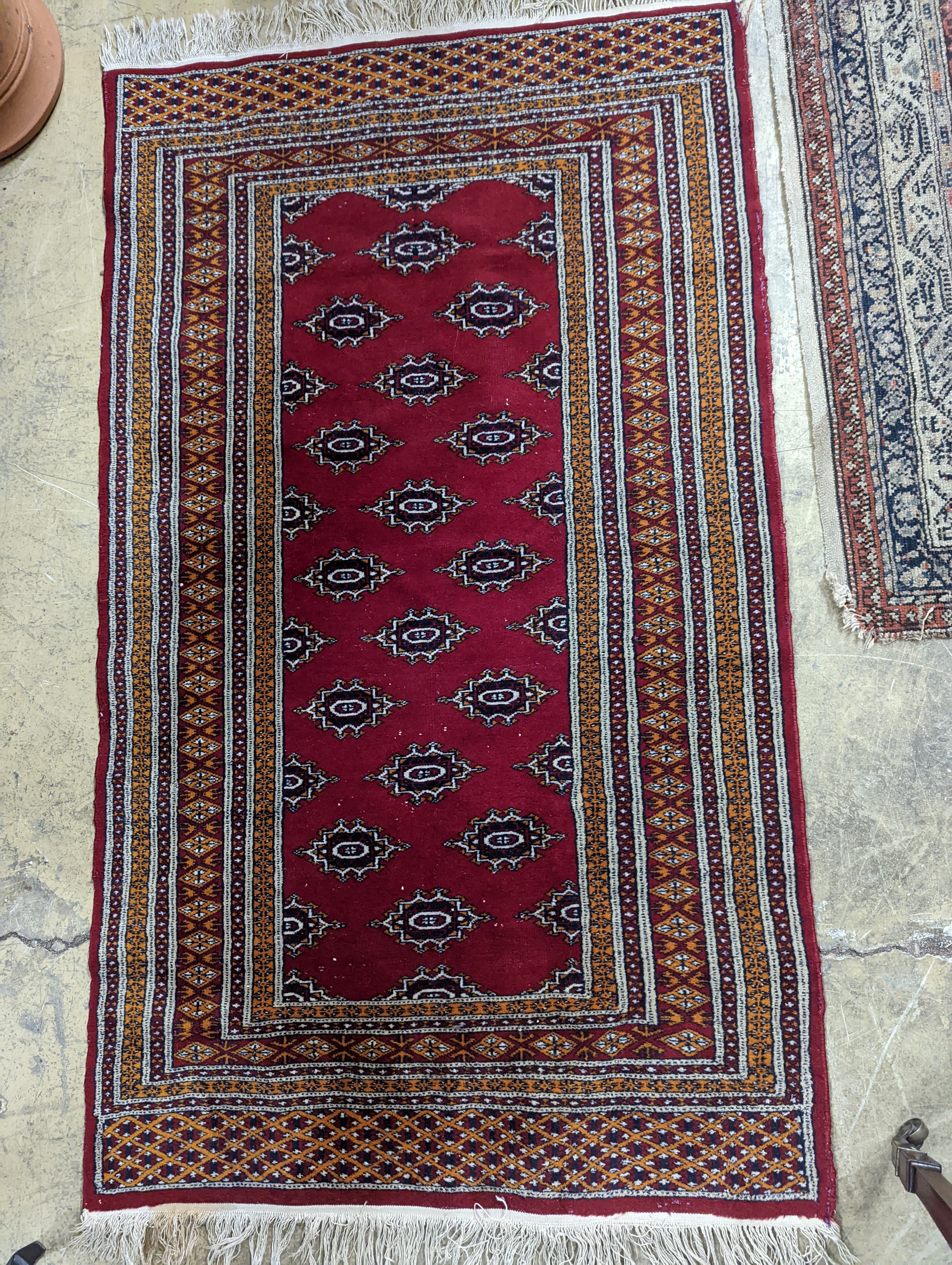 A Bokhara red ground rug, 155 x 88cm